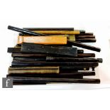 A collection of thirty five mid 20th Century or earlier rulers in ebony and Bakelite to include