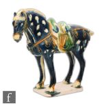 A Tang dynasty style horse modelled in standing position, with blue glazes picked out in green and