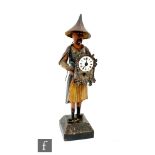 An early 20th clock automaton of a Chinese man wearing a hat and traditional clothes and holding a