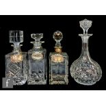 A 20th Century clear cut crystal decanter of square section with matched stopper and silver