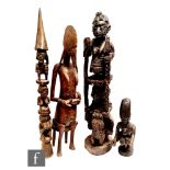 Four African tribal carved figures to include two totem examples, a zoomorphic mother and child