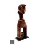 A West African Côte d'Ivoire heddle pulley, probably Senufo, the angular human carved face, raised