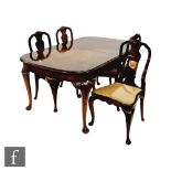 A Queen Anne style walnut extending dining table, the moulded edge top over a plain frieze on scroll