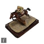 A Border Fine Arts equestrian model of a jockey and horse jumping a hurdle, modelled by D Geenty,