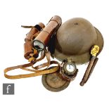 A British tin helmet, a three drawer brass and leather signalling telescope By Dolland London, a