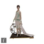 An Albany Fine China model of a 1980s lady in the Art Deco style stood before a bronzed metal