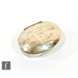 A late 19th Century oval silver snuff or trinket box, the hinged cover engraved 'Presented to the