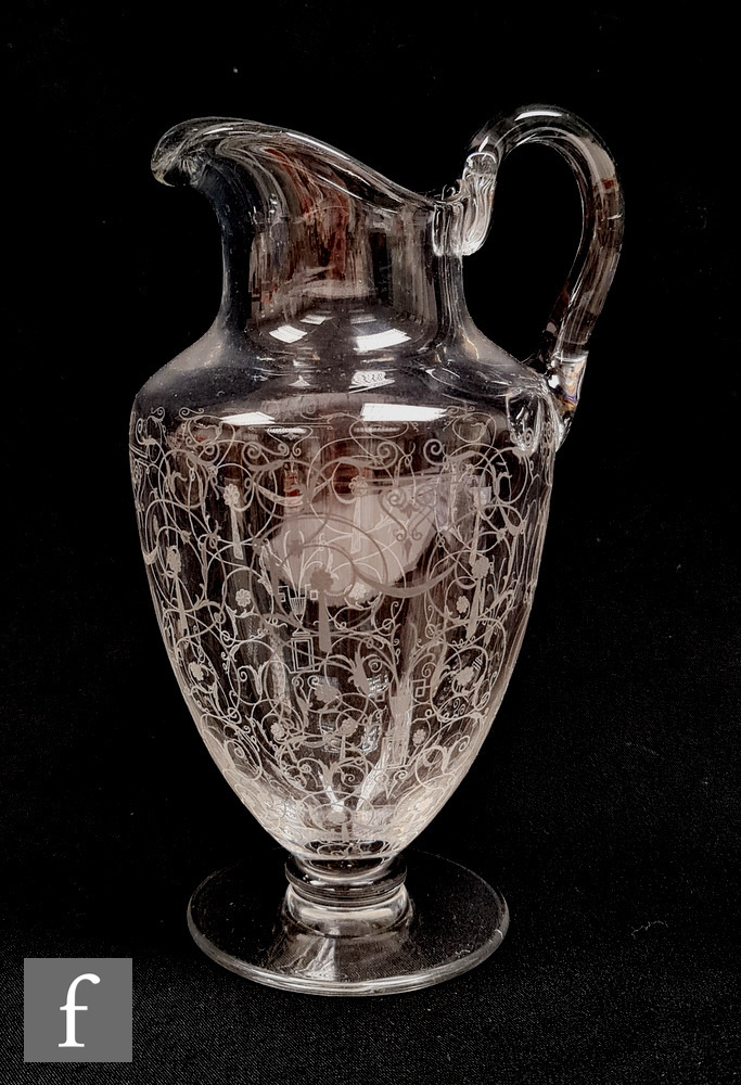 A continental glass jug in the manner of Lobmeyr, of footed ovoid form with applied loop handle,