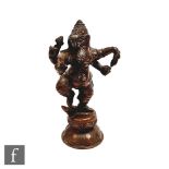 A Sino-Tibetan bronze votive figure of Ganesha raised on a pedestal lotus base, wearing head