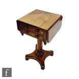 A William IV mahogany drop flap work table fitted with two end drawers, turned wood handles on a