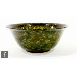 A 20th century Chinese jade stone bowl of shallow circular form with flared rim, unmarked, height