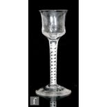 An 18th Century drinking glass circa 1770, with waisted and hammered ogee bowl above a double series