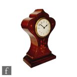 An early 20th Century Art Nouveau balloon shaped mantel clock, the mahogany case with floral and