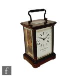 A mid 20th Century Matthew Norman brass carriage clock, Roman numerals to a white enamelled dial.