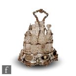 A Victorian hallmarked silver eight bottle cruet stand, the oval skirted base with oval floral
