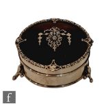 A hallmarked silver and tortoise shell circular trinket box with inlaid silver swag detail to hinged