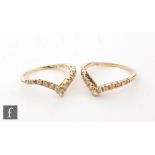 Two 18ct diamond set wishbone rings each set with thirteen stones, total weight 4g, ring size L. (2)