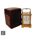 A late 19th Century miniature French brass carriage clock, bevelled glass case on bracket plinth,