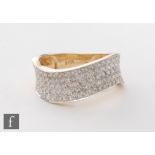 An 18ct modern pave set diamond ring comprising five rows of diamonds to a wave design, weight 4.