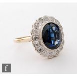 An 18ct hallmarked blueberry quartz and diamond cluster ring, central collar set quartz, length