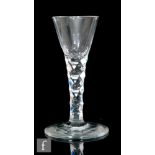 An 18th Century wine glass circa 1785, the conical bowl above a diamond faceted stem, raised to a