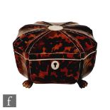 A 19th Century tortoiseshell sarcophagus tea caddy with laid mother of pearl escutcheon and