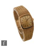 A 9ct hallmarked lady's Omega manual wrist watch, batons to a square, champagne dial, all to an