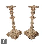 A pair of hallmarked silver candlesticks, shaped square bases below knop column, plain capitals