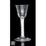 An 18th Century drinking glass circa 1765, the round funnel bowl with basal flutes above a double