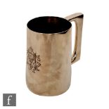A hallmarked silver pint tankard of plain form engraved with initials to front, height 11cm,