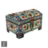 An early 20th Century Russian silver and cloisonne dome topped casket raised on four strut feet, the