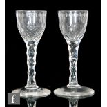 A pair of 18th Century drinking glasses circa 1785, each with an ovoid bowl engraved with an OXO