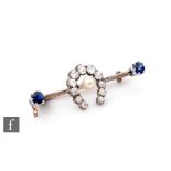 An early 20th Century 9ct bar brooch with central single pearl within a diamond set horseshoe and