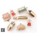 Nine assorted 9ct hallmarked charms to included a bottle, two pairs of gold mounted dice, two folded