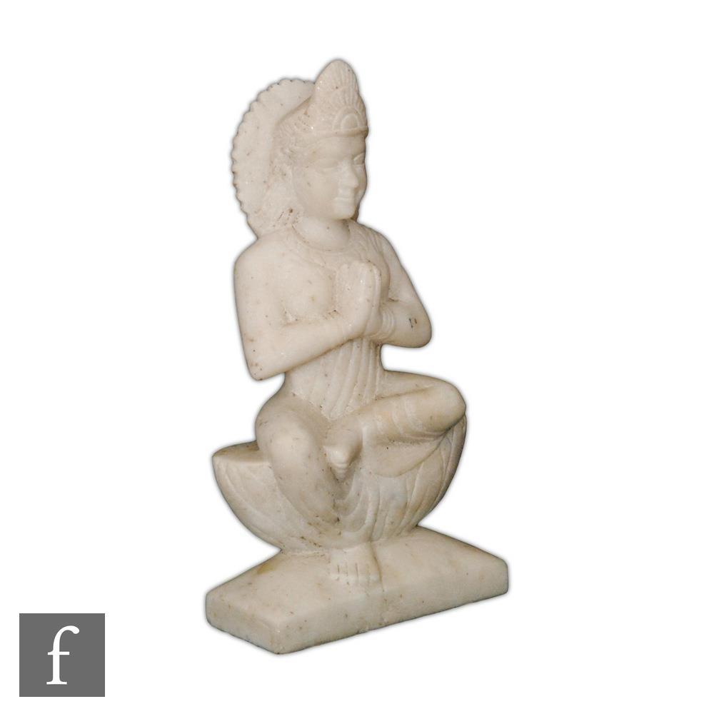 An Indian alabaster figure of Tara, hands cast Anjali, in seated position raised on a plinth base,