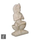 An Indian alabaster figure of Tara, hands cast Anjali, in seated position raised on a plinth base,