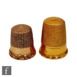 Two gold thimbles, one with a band of chased decoration, both unmarked, both tested as 9ct.