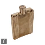A hallmarked silver rectangular hip flask with engine turned decoration below bayonet cap, cap