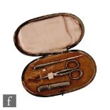 A late 19th to early 20th Century etui, the rounded case containing stiletto, scissors and a