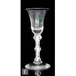 An 18th Century wine glass circa 1765, the bell bowl above a double series opaque twist stem with