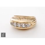 An 18ct diamond five stone ring, high collar set old cut stones to an arched head with pierced