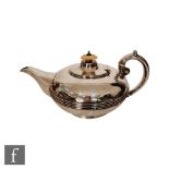 An Irish silver melon shaped tea pot of plain form with reeded central band, terminating in scoll