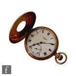 A 9ct hallmarked crown wind half hunter pocket watch, with Roman numerals to a white enamelled dial,