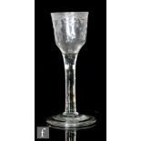 An 18th Century drinking glass circa 1740, the ogee bowl with engraved swag border to rim and