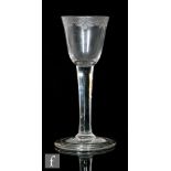 An 18th Century wine glass circa 1740, the round funnel bowl engraved with a swagged band above a