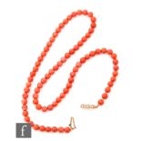 A single row of uniform coral beads each approximately 4mm, all to a 9ct snap, length 44cm.