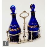 A pair of 19th Century Bristol Blue decanters, of Indian club form, with gilded 'Rum' and 'Brandy'