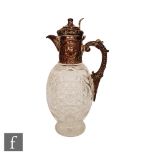 A Victorian hallmarked silver mount to a claret jug with foliate embossed decoration and terminating