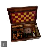 An early 20th Century mahogany inlaid games compendium with a harlequin assortment of playing