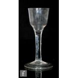 An 18th Century wine glass circa 1750, the ogee bowl above a plain stem, raised to a folded foot,